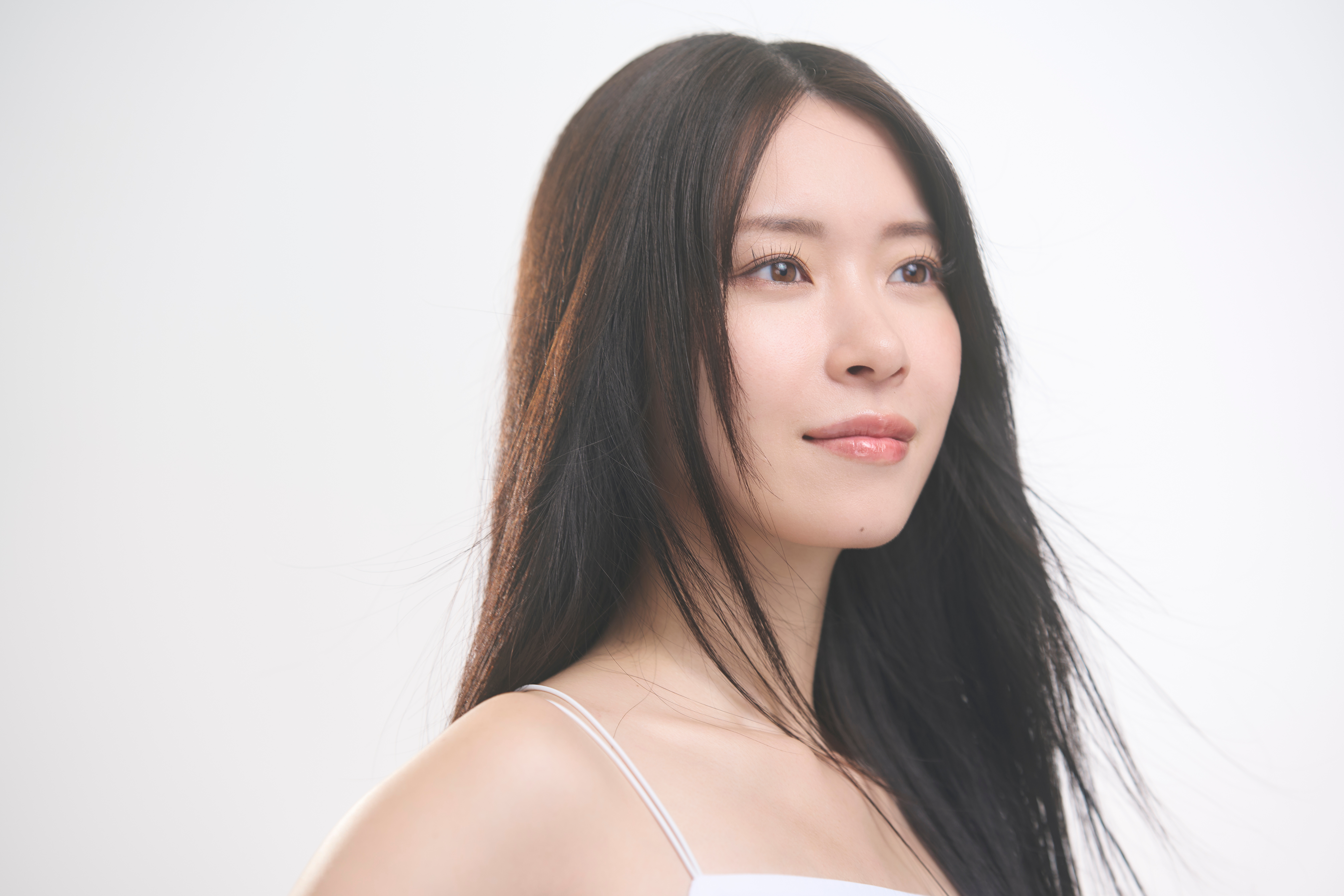 二重施術後の自然な仕上がりをイメージさせる明るい笑顔の女性